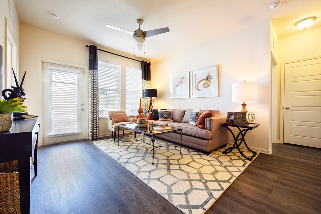 a living room with a couch and a ceiling fan
