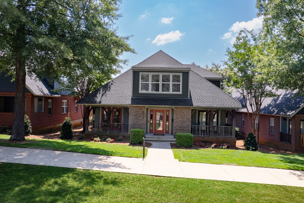 A house with a red brick exterior and a grey roof.
