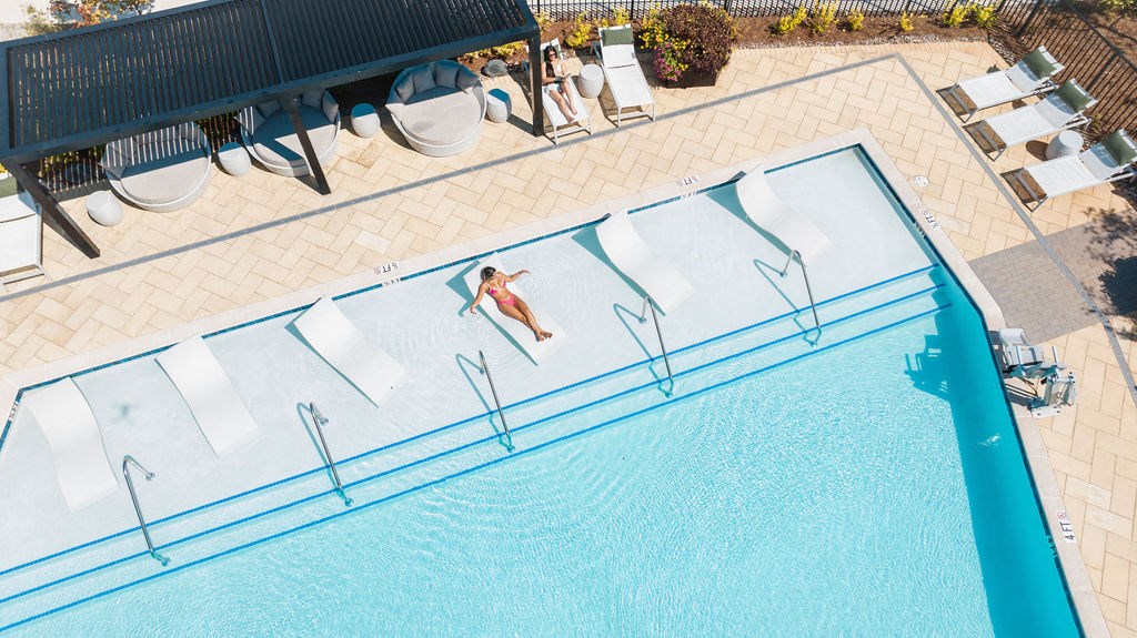 a woman swims in a pool at a resort