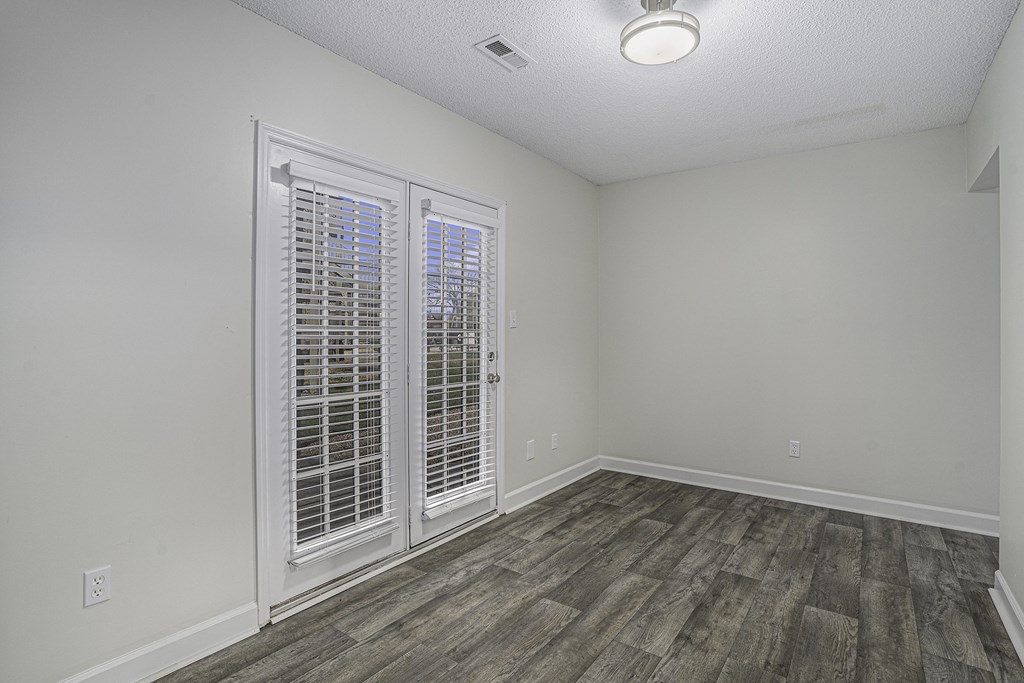 an empty living room with white walls and white doors