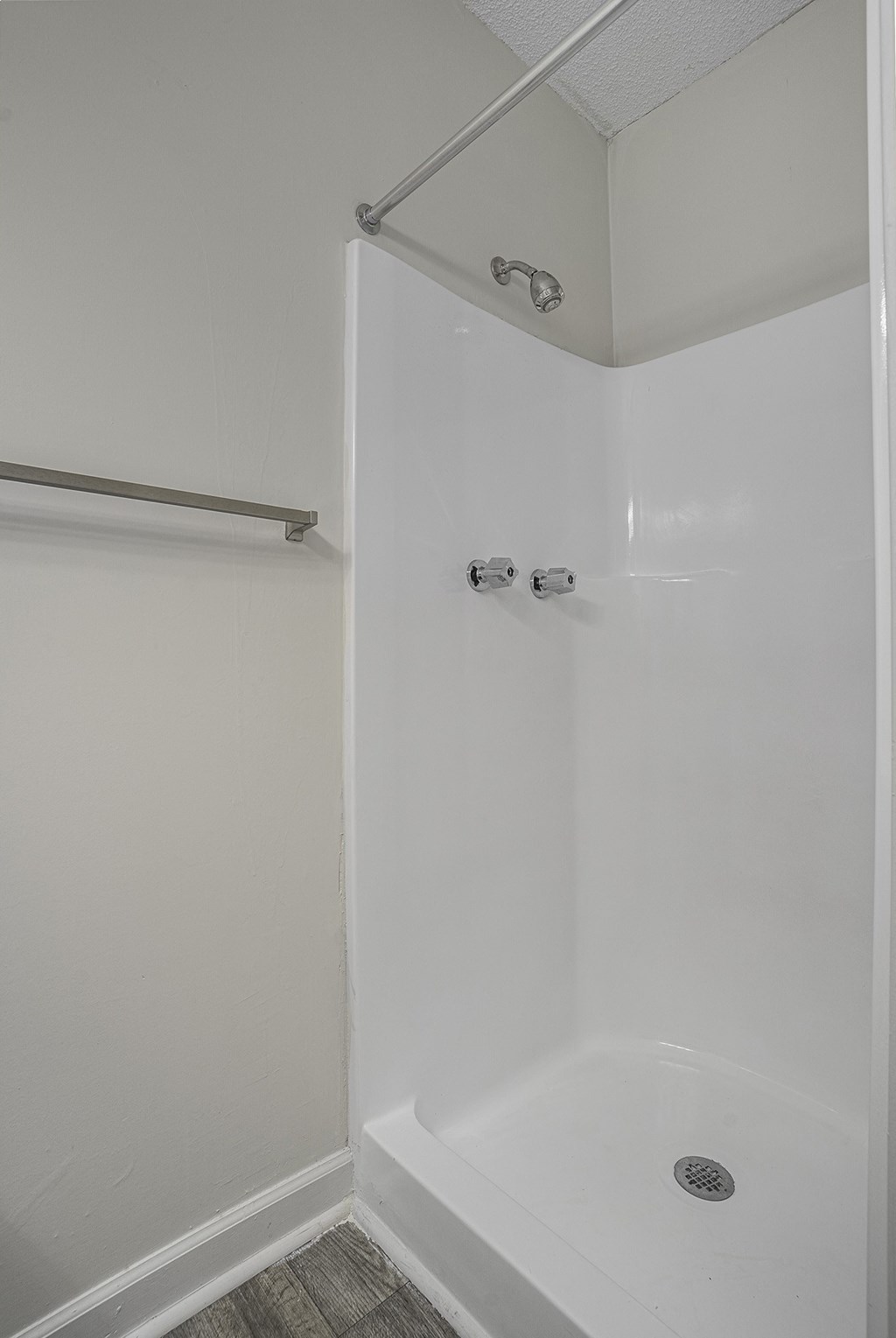 an empty shower in a bathroom with a shower curtain