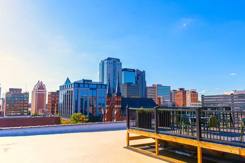 a view of the skyline of a city with a bench