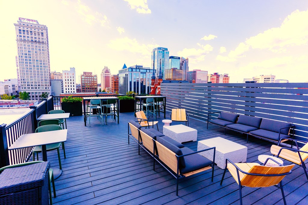 Downtown Birmingham, AL Apartments - Rooftop Deck With Couches, Tables, Chairs, Potted Plants, And Views Of The Downtown Area.