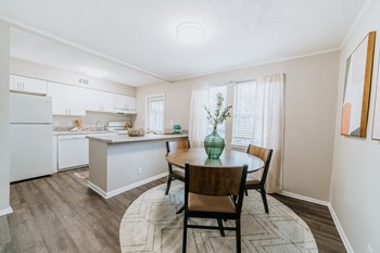 Kitchen with island and white cabinets Living Room at Midtown Oaks Townhomes in Mobile, AL Open Concept Kitchen and Dining Room at Midtown Oaks Townhomes in Mobile, AL - Photo Gallery 3
