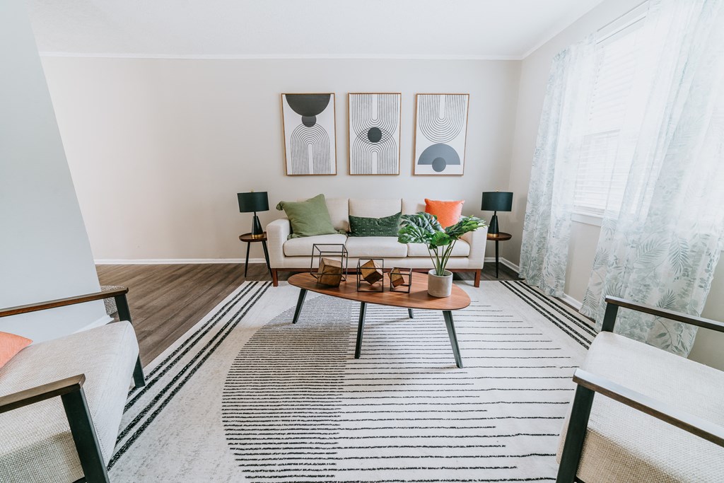 large windows and wood floors Living Room at Midtown Oaks Townhomes in Mobile, AL Roomy living room with bright light Living Room at Midtown Oaks Townhomes in Mobile, AL