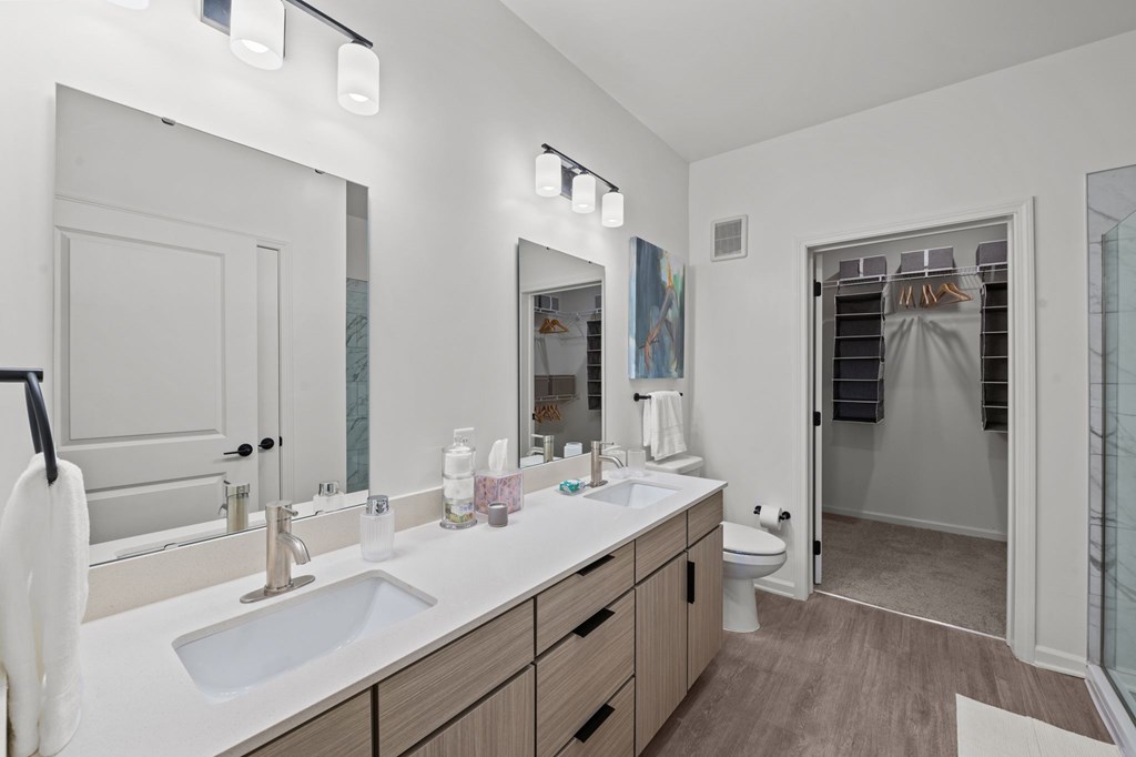 A bathroom with a white sink and a mirror above it.