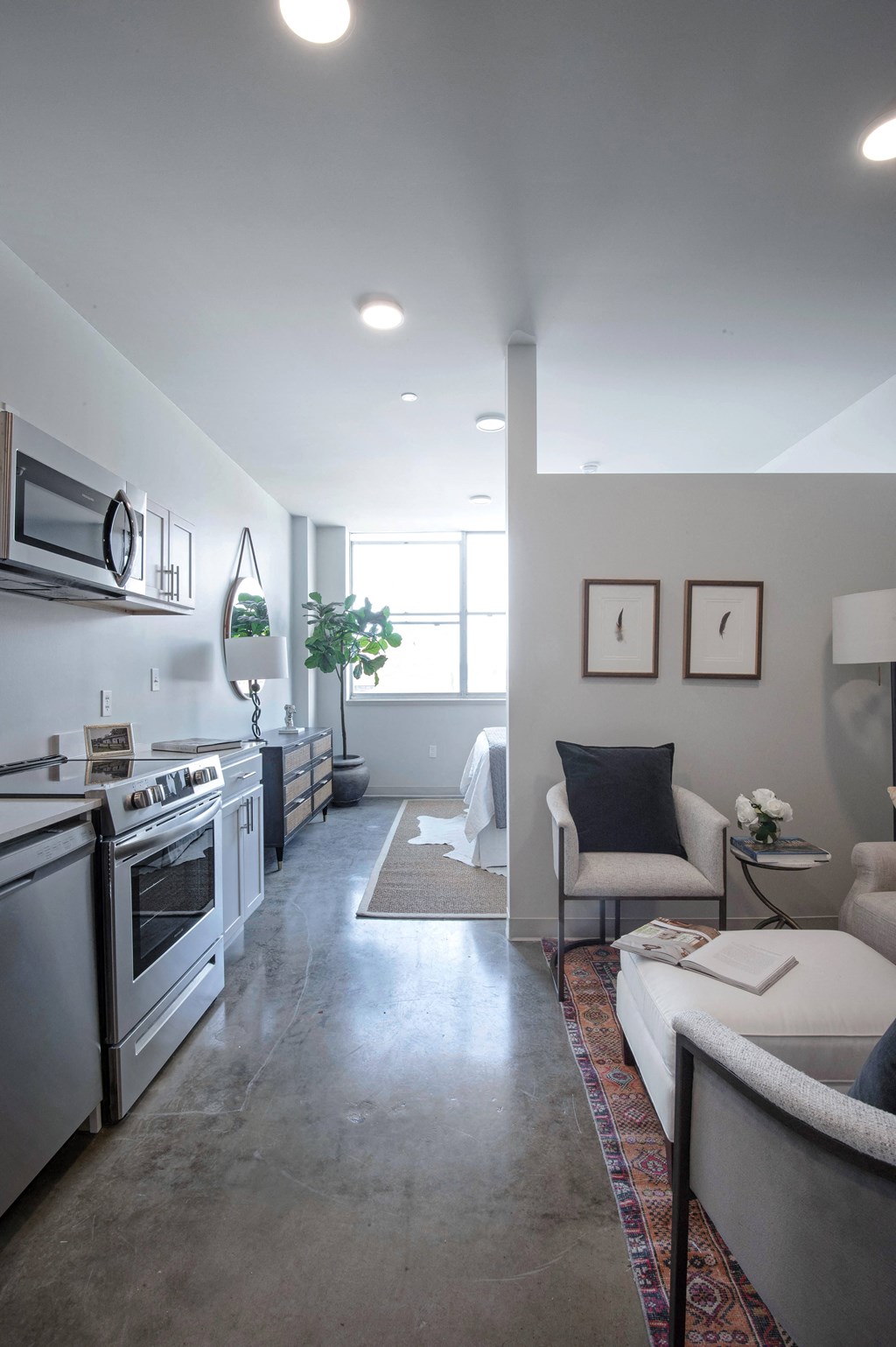 a kitchen and living room with a stove and a microwave