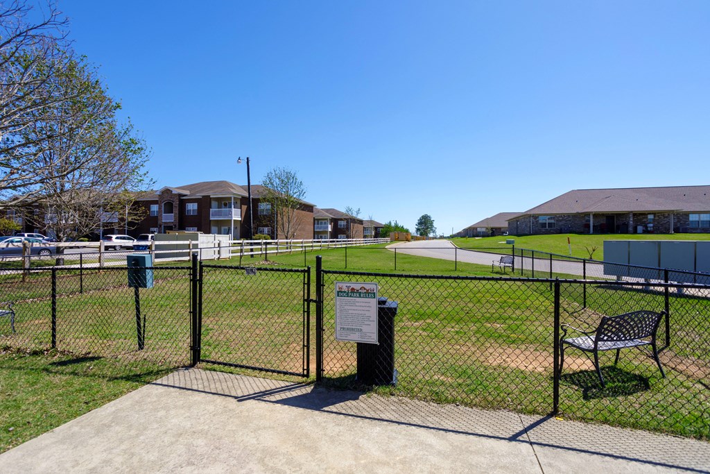 fenced dog park with benches at Deerfield Apartments in Florence, AL