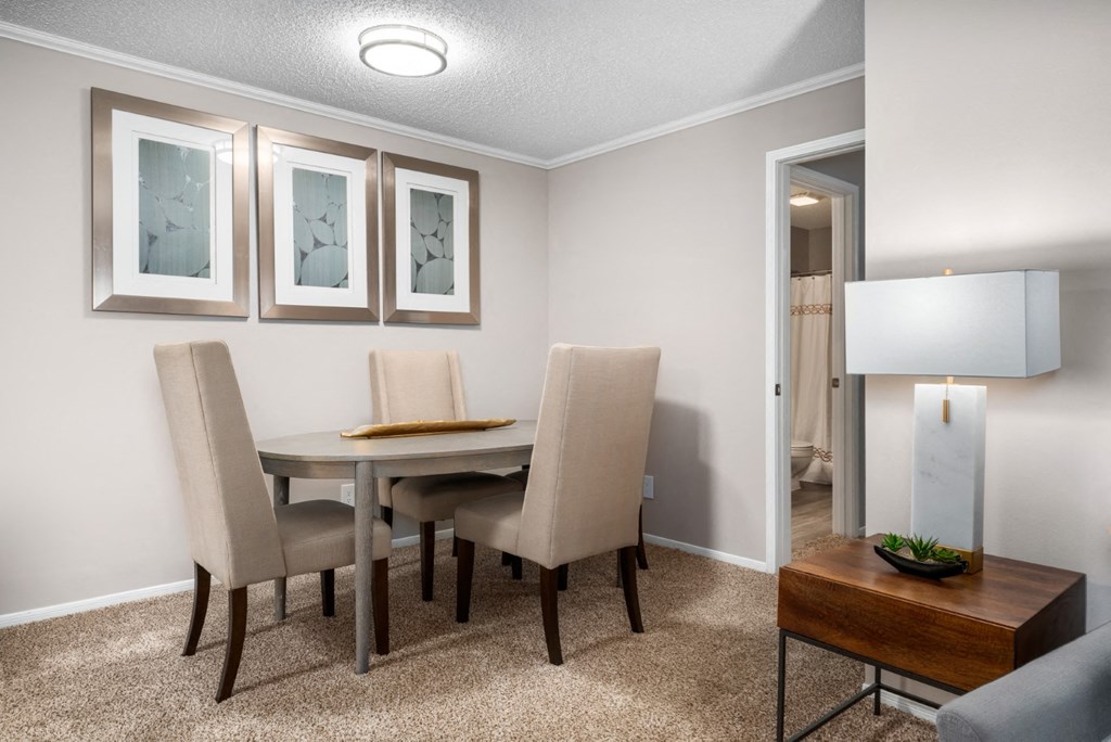 Carpeted dining room with modern lighting at Summerchase at Riverchase in Hoover, Alabama