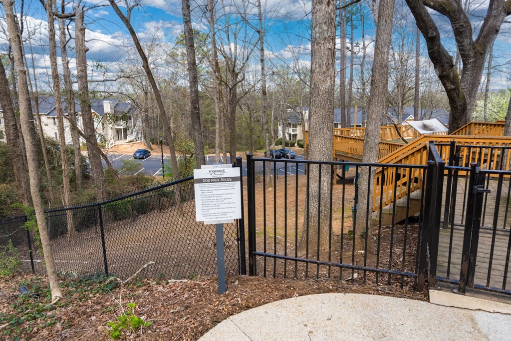 Dog park overlooking apartment buildings and woods at Summerchase at Riverchase in Hoover, Alabama