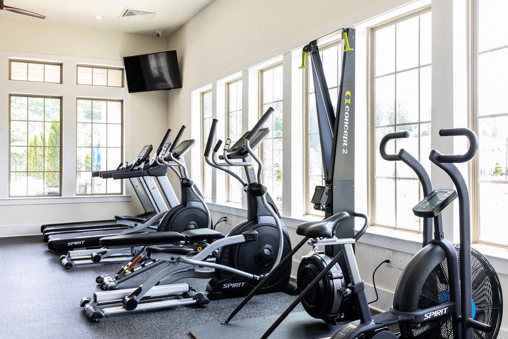 a row of spin bikes in a gym