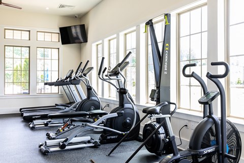 a row of spin bikes in a gym