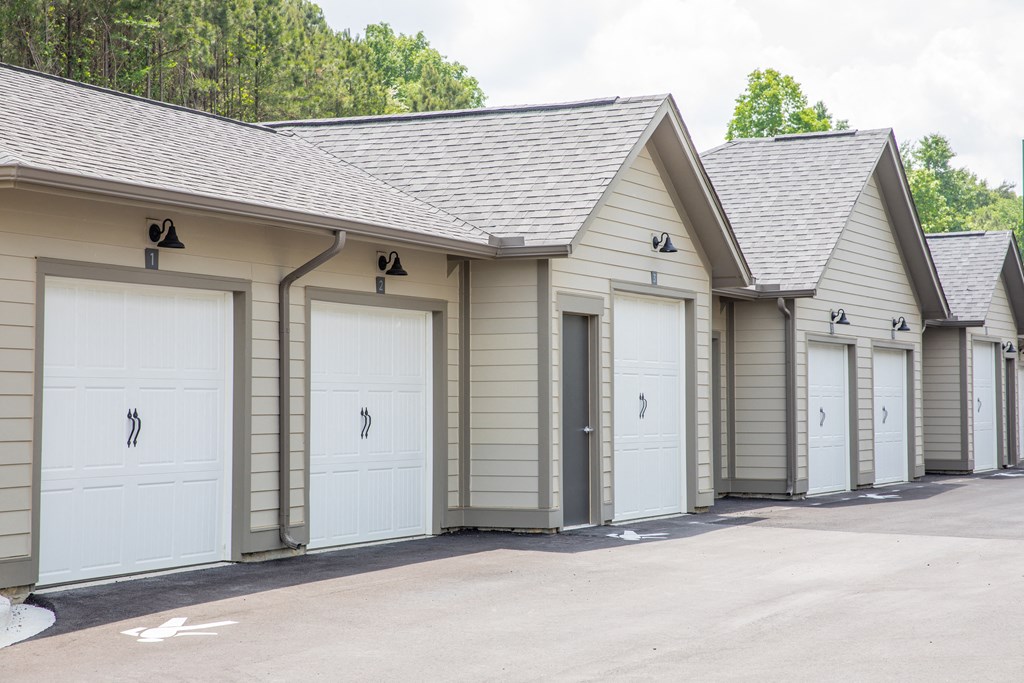 a row of garages with white garage doors