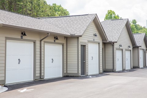 a row of garages with white garage doors