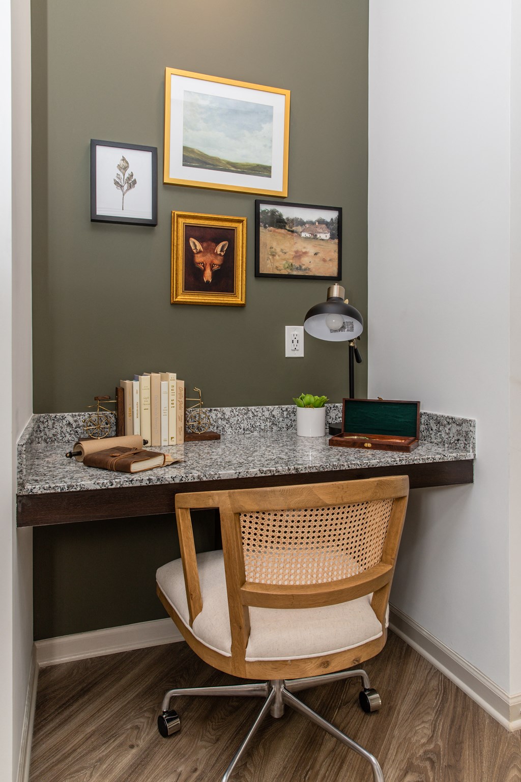 a desk with a computer and a chair in a room