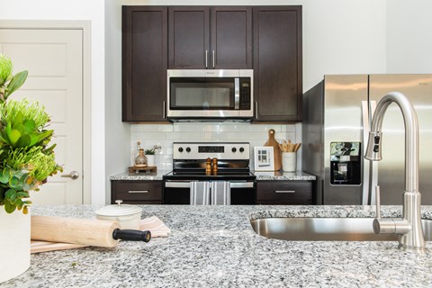 a kitchen with stainless steel appliances and granite counter tops