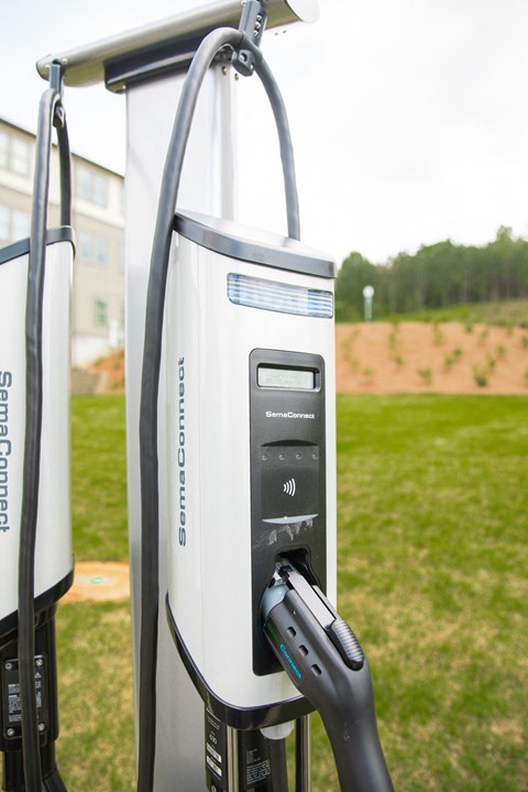 an electric charger is plugged into a power station