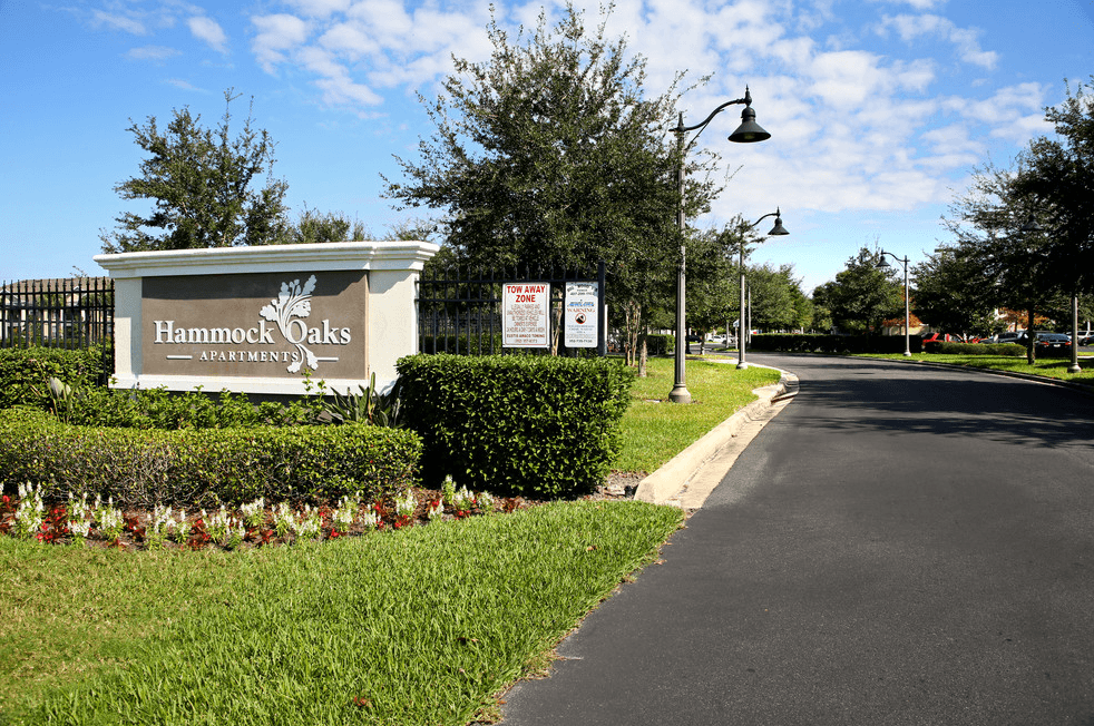 a sign for hammock oaks on the side of a road