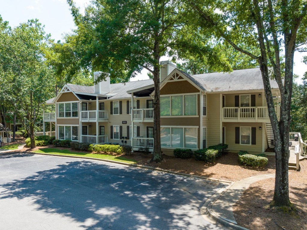 Exterior view of apartment building, trees and landscaping at Summerchase at Riverchase in Hoover, Alabama