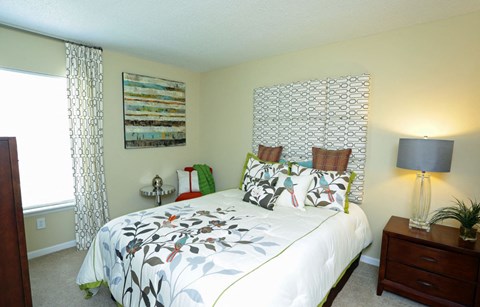 a bedroom with a large bed and a window