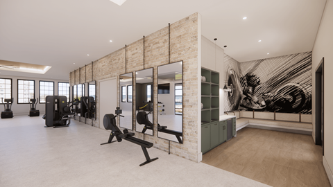 A gym with a brick wall and a mirror.