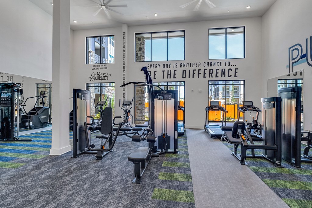 a fitness center with cardio equipment and resistance training at Tapestry Overbrook in McDonough, Georgia