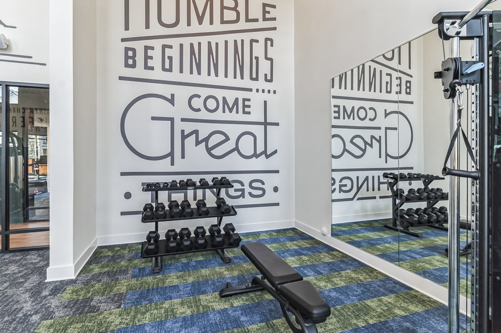 a gym with weights at Tapestry Overbrook in McDonough, Georgia