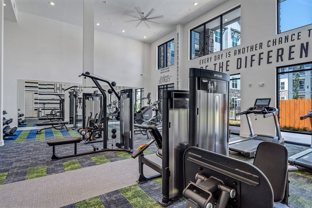 the gym with cardio equipment at Tapestry Overbrook in McDonough, Georgia