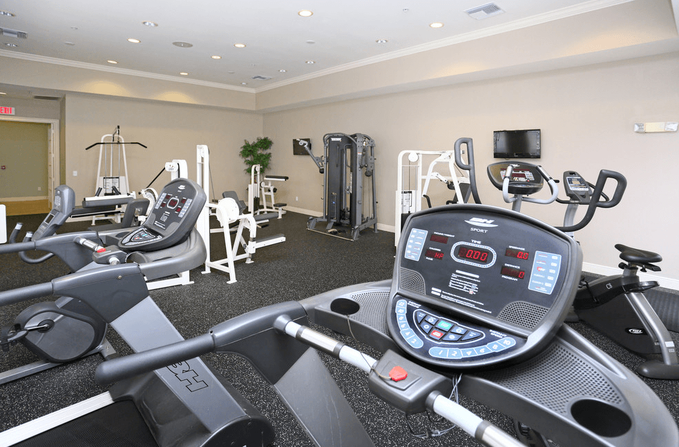 a gym with cardio machines and other exercise equipment