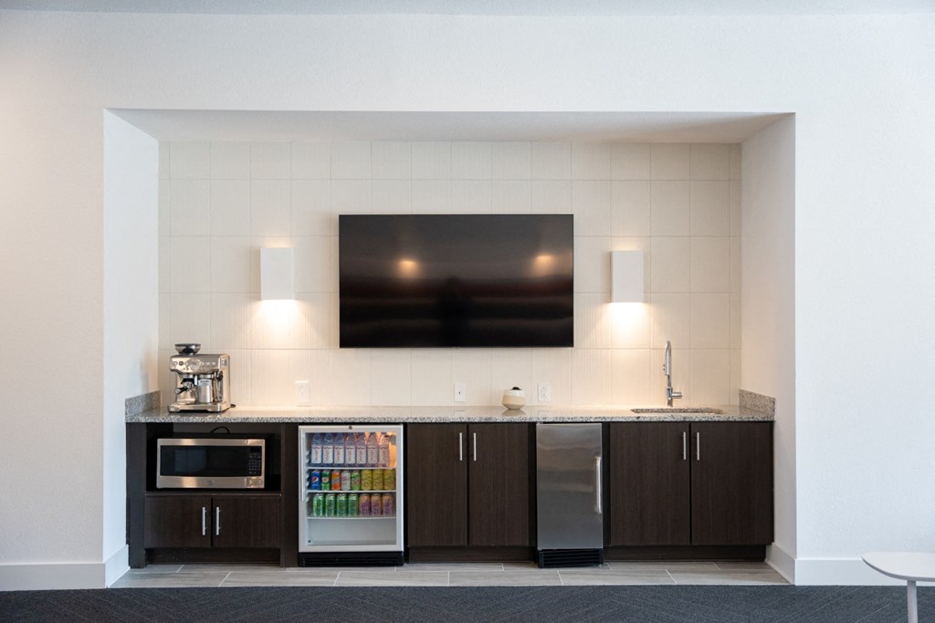 a kitchen with a counter and a microwave and a television at 20 Midtown, Alabama, 35233