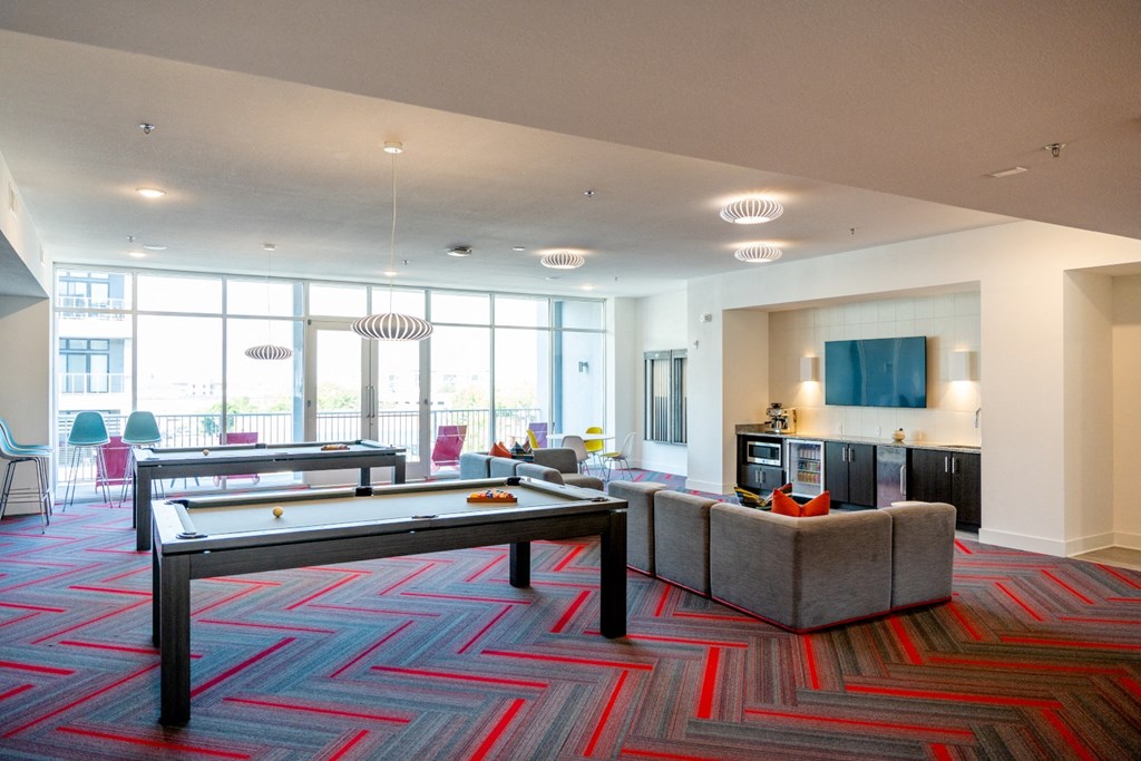 a large living room with a pool table and couches at 20 Midtown, Birmingham, Alabama