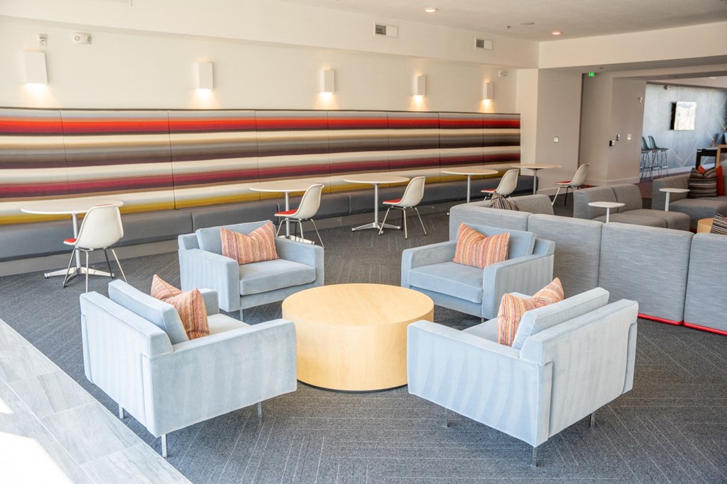 a seating area in a lobby with chairs and tables at 20 Midtown, Birmingham, Alabama