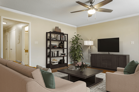 A living room with a beige couch, a black bookshelf, a coffee table, and a flat-screen TV.