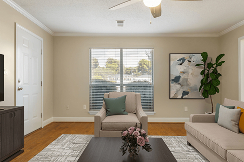A living room with a brown couch, a chair, and a coffee table.