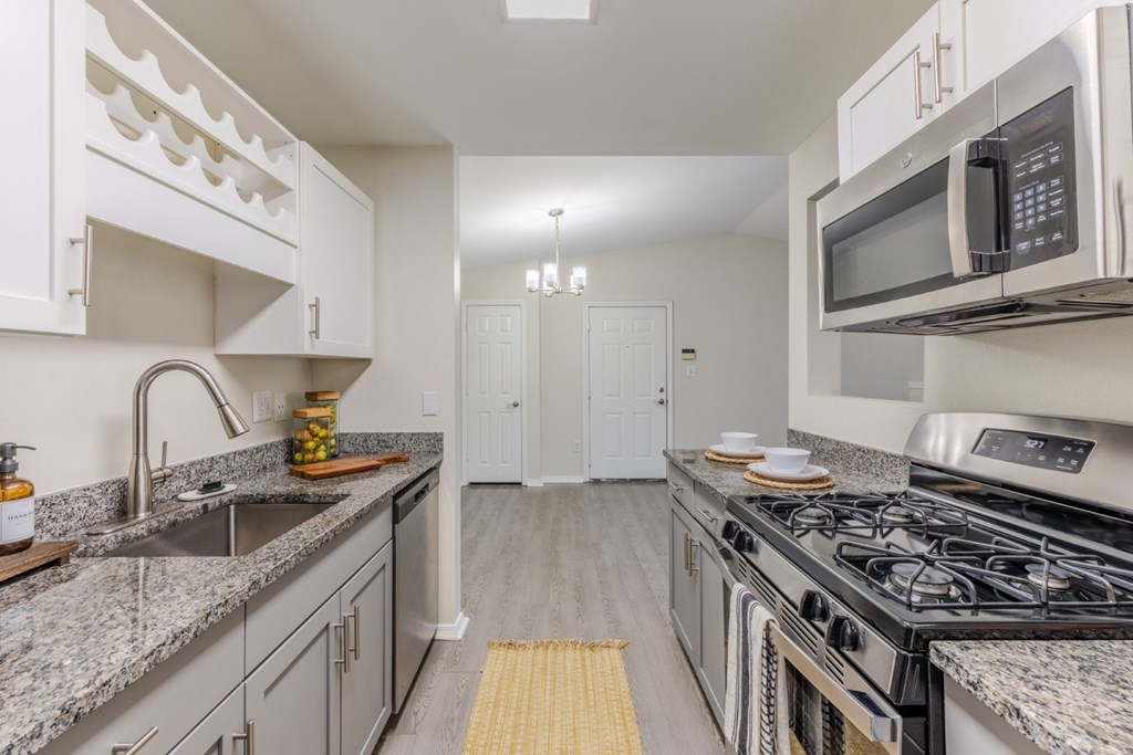 A kitchen with granite countertops and stainless steel appliances  at Grande View Apartments in Biloxi, M