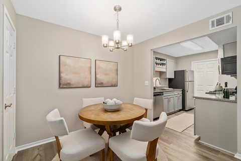 A dining room with a table set for two.