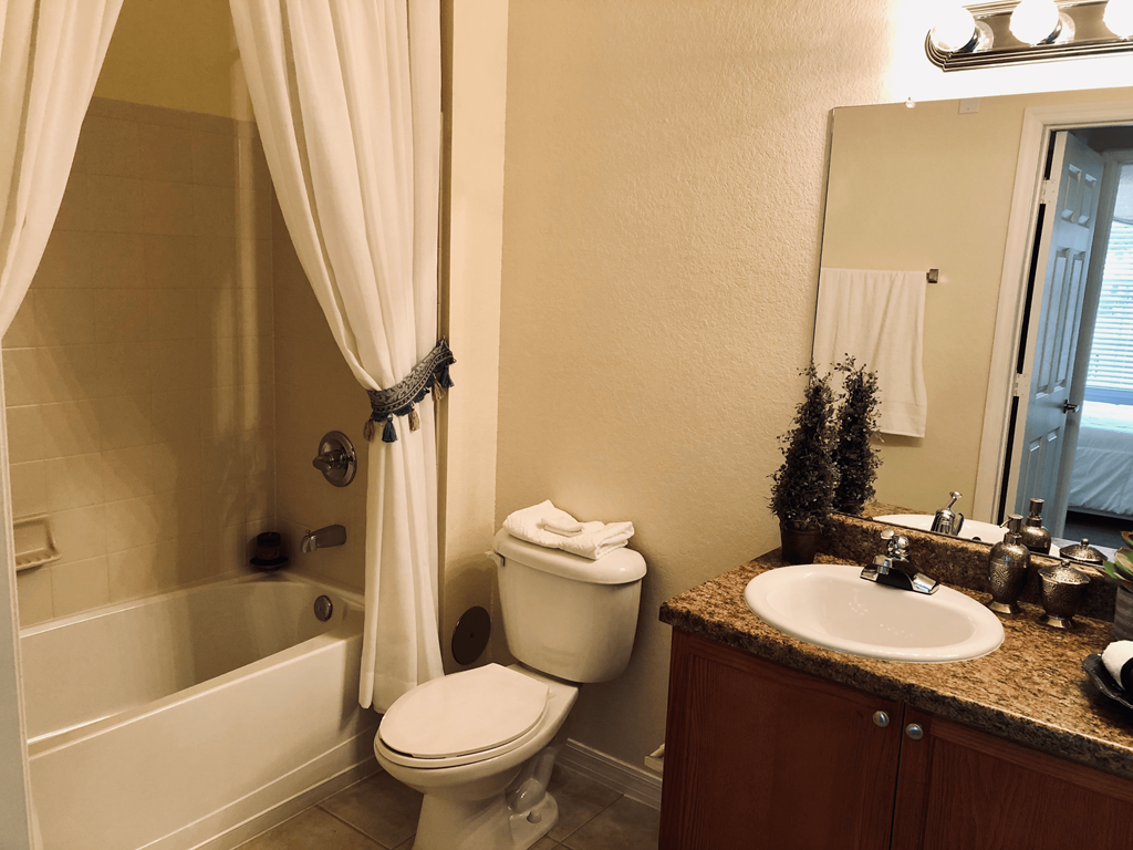 a bathroom with a sink toilet and bath tub
