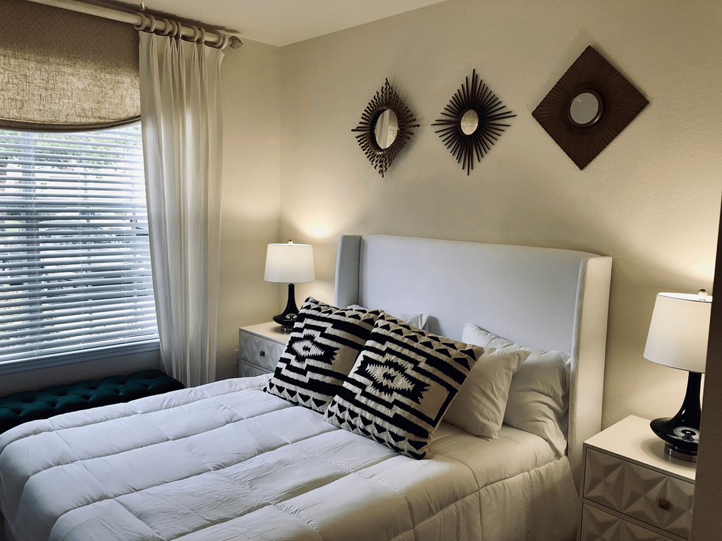 a bedroom with a large white bed and pillows