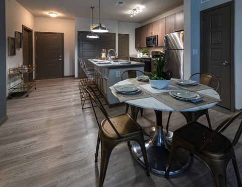 a kitchen and dining room with a table and chairs