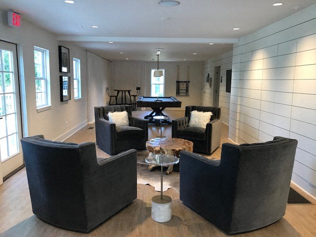 a living room with couches and chairs and a table