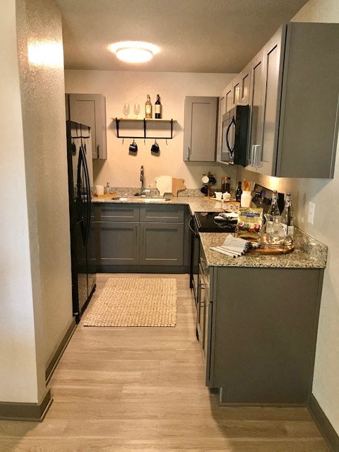 a kitchen with gray cabinets and a counter top