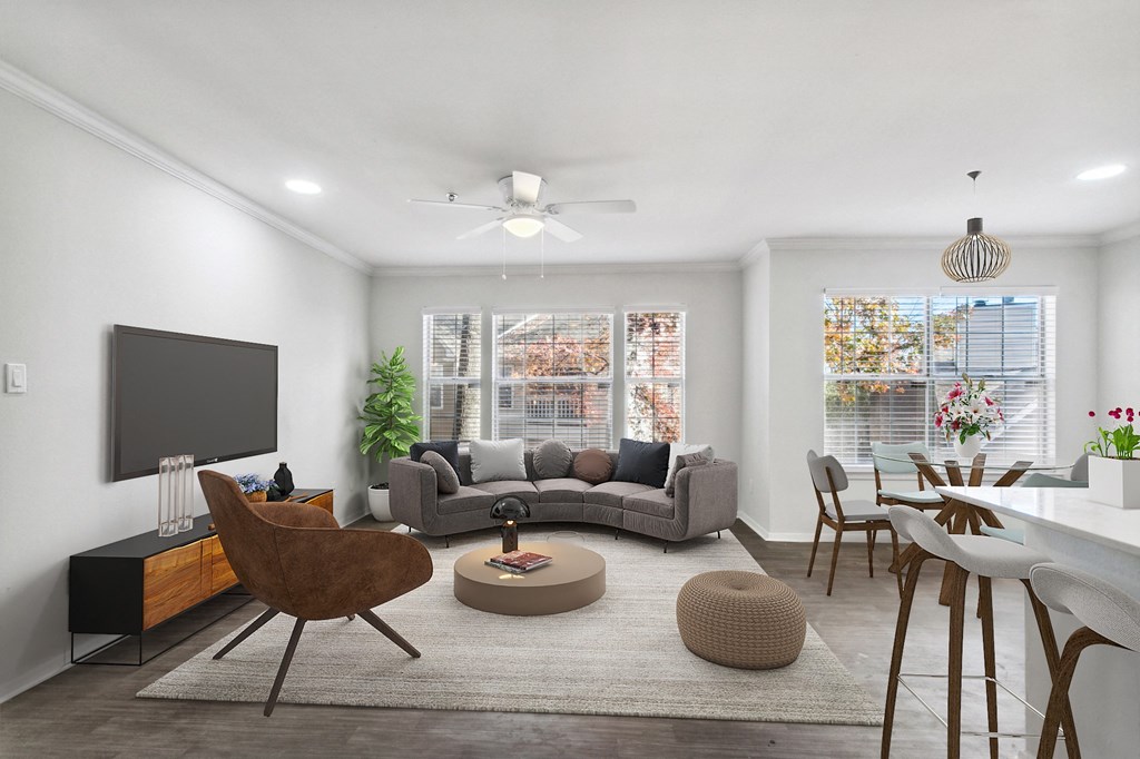 a living room and dining room with a couch and a tv