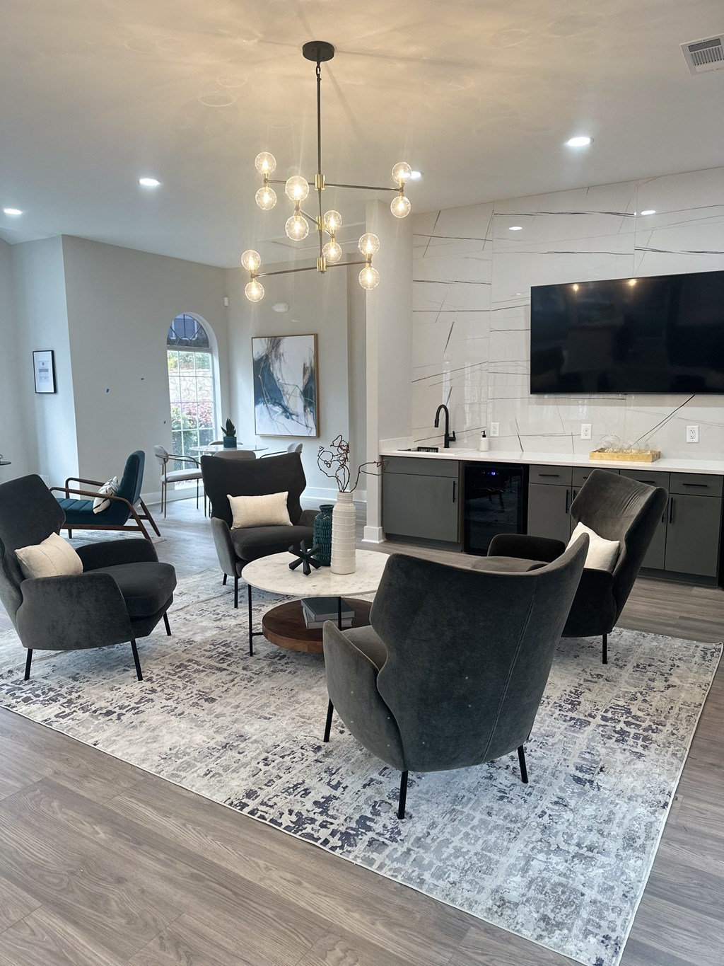 a living room and kitchen with chairs and a table