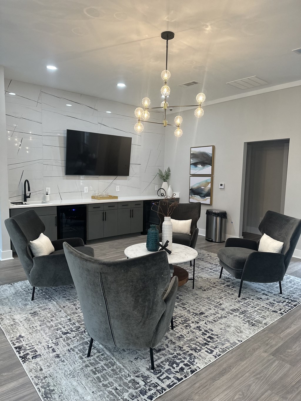 a living room with a kitchen and a tv