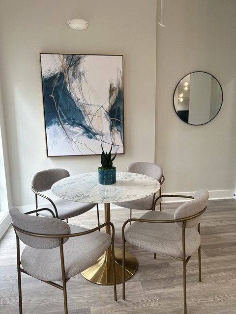 a dining room with a marble table and chairs