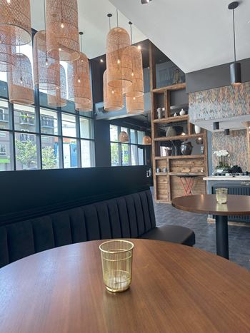 a dining room with a wooden table and a large window