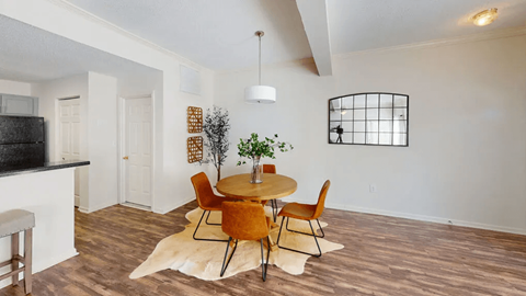 A dining room with a table set for four.