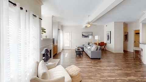 A living room with a white couch and a television.