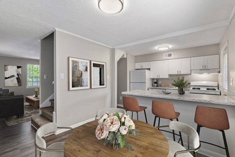 a dining room and kitchen with a table and chairs