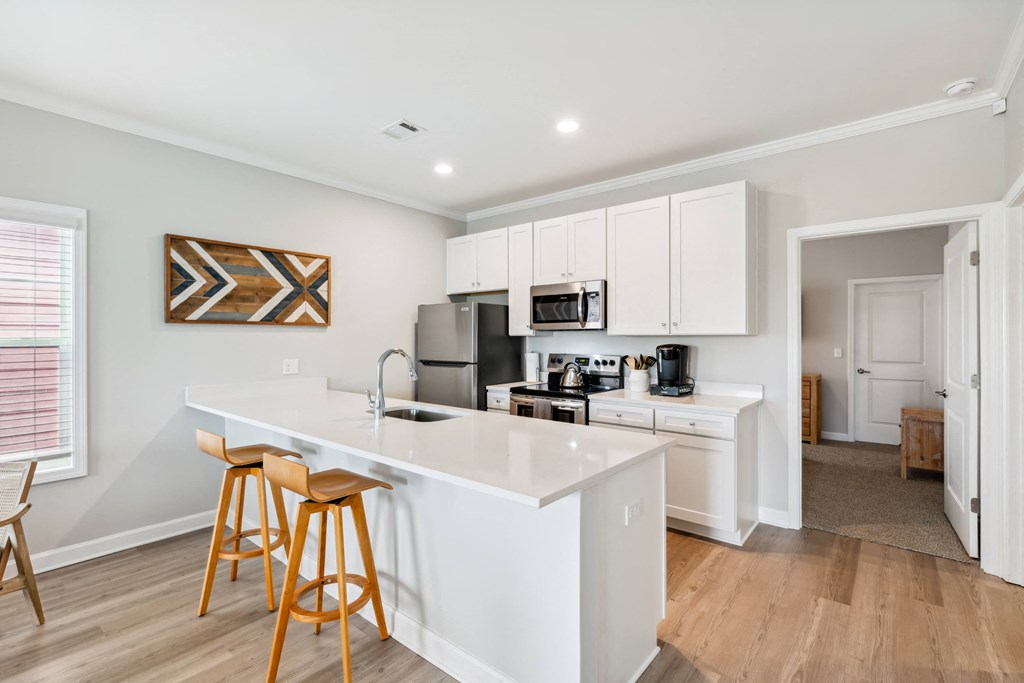 a kitchen with a large island and two bar stools
